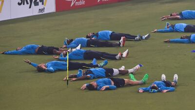 South African cricketers warm-up during a practice session at the Gaddafi Cricket Stadium. AFP