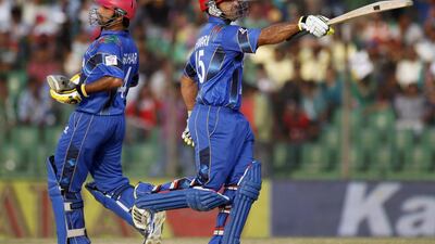 Afghanistan’s Samiullah Shenwari celebrates after scoring a half century that gave the team a vital edge in posting a target Bangladesh failed to surpass on Saturday, March 1, 2014. Andrew Biraj / Reuters