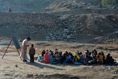 School children take part in a lesson in an open-air classroom in Qarghayi district of Laghman Province, Afghanistan. AFP