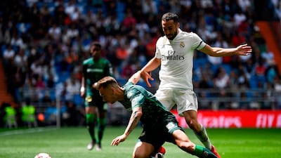 Real Madrid defender Dani Carvajal, right, challenges Real Betis forward Loren Moron. AFP