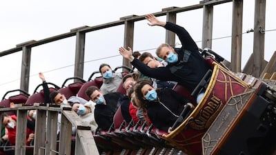 Visitors ride on a rollercoaster at Europa Park in Rust, western Germany, on the re-opening day of the park following the lifting of coronavirus restrictions. AFP