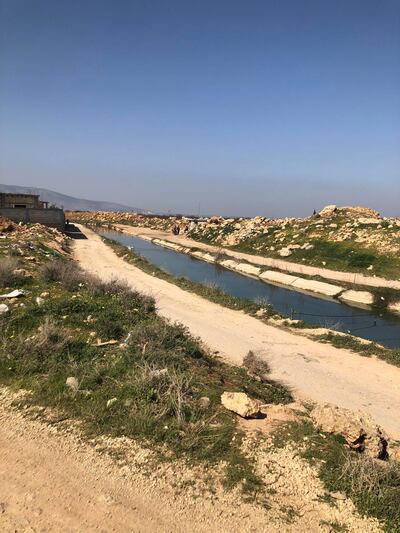 A narrow water channel forms the border with Syria in Lebanon's Baalbek-Hermel region. Aya Iskandarani / The National