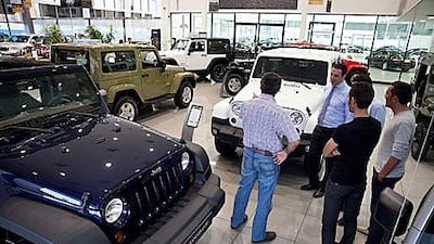 Potential customers check out Jeep SUVs as they shop around in Abu Dhabi. Consumer borrowing has surged recently. Silvia Razgova / The National