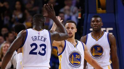 Stephen Curry high-fives Draymond Green during the Golden State Warriors’ NBA victory over the San Antonio Spurs on Monday night. Ezra Shaw / Getty Images / AFP
