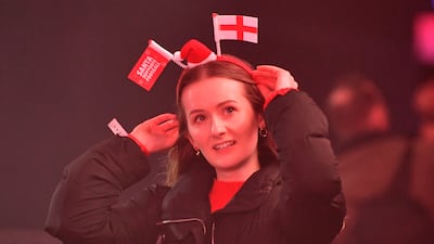 A woman wears an England-themed headband as supporters gather to watch the World Cup in Manchester. Getty Images