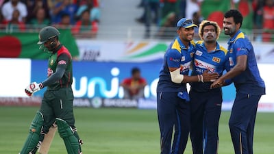 Sri Lanka's Lasith Malinga, second right, celebrates with teammates the dismissal of Bangladesh's Mohammad Mithun, left, during the one day international cricket match of Asia Cup between Sri Lanka and Bangladesh in Dubai, United Arab Emirates, Saturday, Sept. 15, 2018. (AP Photo/Aijaz Rahi)