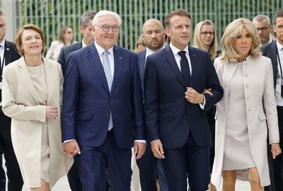German President Frank-Walter Steinmeier, second left, his wife Elke Buedenbender, left, with French President Emmanuel Macron and his wife Brigitte, in Berlin on Sunday. AFP