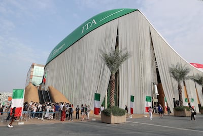 Visitors on Monday outside the Italy pavilion, which was closed for a short period to repair rain damage. Pawan Singh / The National