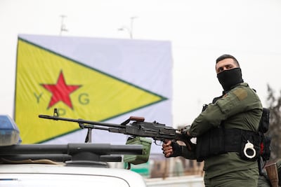 A member of the Kurdish internal security forces awaits for the arrival of Syrian government forces in Qamishli. Reuters