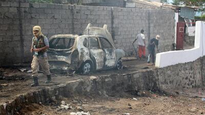 Yemeni loyalist forces and onlookers gather at the scene of a suicide attack targeting Aden’s police chief Maj Gen Shalal Shaei in Aden on April 28, 2016. Saleh Al Obeidi / AFP