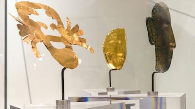 Why have so many cultures used gold to venerate the dead? Shown, golden funerary masks from, left to right: Peru (100 BCE - 700 CE); the Levant (600 - 300 BCE); Northern China (907 -1125 CE). Christopher Pike / The National