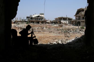 A Free Syrian Army fighter sits with his weapon in Al Manshiyeh neighbourhood of Deraa, Syria, on July 21. Alaa Al Faqir / Reuters