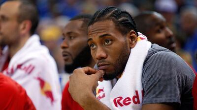 Kawhi Leonard of the San Antonio Spurs shown on the bench during his team’s loss to the Golden State Warriors. Ezra Shaw / Getty Images / AFP
