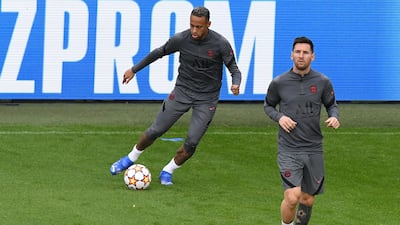 PSG's Lionel Messi with Neymar kicking the ball in the background. AFP