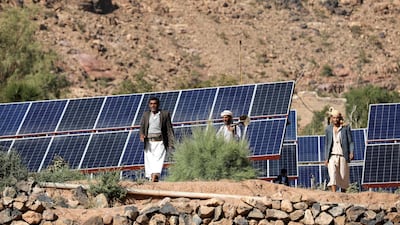 Farmers walk next to solar panels at a farmland in Wadi Dhahr near Sanaa, Yemen October 28, 2019. Picture taken October 28, 2019. REUTERS/Khaled Abdullah