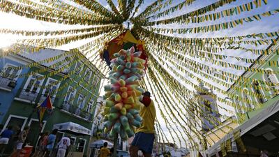A street vendor sells candy floss in Pelourinho, the historical centre of Salvador, where Islamic countries Iran and Bosnia will play on Thursday. Guillaume Horcajuelo / EPA
