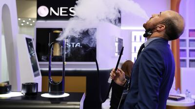 A sales representative shows how the pipe delivers nicotine via vibrations.