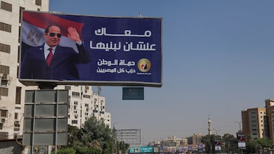 A billboard in Cairo featuring Egypt's President Abdel Fattah El Sisi. 'We are with you to build,' it declares. Reuters