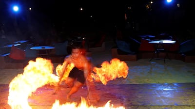 A fire dancer performs in a near empty beach bar, hours before the shutdown of the holiday island Boracay, in the Philippines on April 25, 2018. Erik De Castro / Reuters