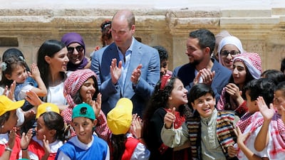 Britain's Prince William and Jordan's Crown Prince Hussein interact with children at the ancient city of Jerash, Jordan on Monday. AFP