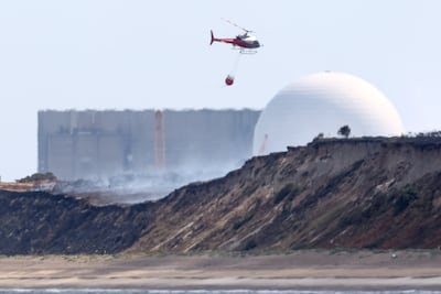 A firefighting helicopter near Sizewell nuclear power stations in the UK after a coastal heathland blaze started on July 29. Reuters