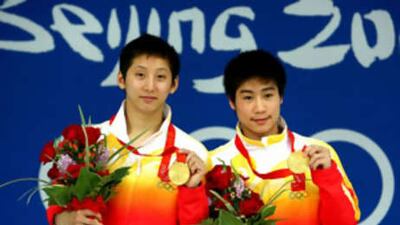 Lin Yue, left, and Huo Liang of China receive their gold medals.