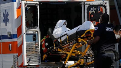 A passenger from Emirates flight EK203 to New York is taken by stretcher to an ambulance at JFK International Airport. EPA