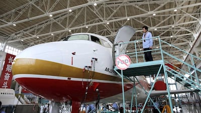 A technician inspects an ARJ21-700 aircraft at the Comac factory in Shanghai. China launched the ARJ21 project in 2002 in an attempt to break into the Western-dominated aircraft market and is targeting the domestic market and flights to Southeast Asia. Carlos Barria / Reuters