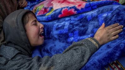 A young Kashmiri boy wails near the body of Asadullaha Kumar during his funeral in Mandhaal village, about 70 Kilometres south of Srinagar. Dar Yasin / AP Photo