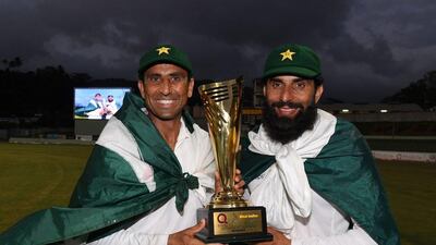 Retiring Pakistan cricketers Younis Khan, left, and captain Misbah-ul-Haq celebrate with the series trophy after winning the final Test match against the West Indies and the series 2-1 at the Windsor Park Stadium in Roseau, Dominica on May 14, 2017. Mark Ralston / AFP