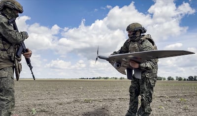 Russian soldiers launch a reconnaissance drone. EPA
