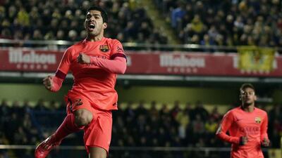 Barcelona's Uruguayan forward Luis Suarez (L) celebrates his goal during the Spanish Copa del Rey match against Villarreal at El Madrigal stadium on March 4, 2015. AFP PHOTO / JOSE JORDAN