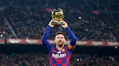 Barcelona's Lionel Messi shows the supporters his sixth Golden Ball for the best player of the year that he was awarded earlier in the week, before a Spanish La Liga soccer match between Barcelona and Mallorca at Camp Nou stadium in Barcelona, Spain, Saturday, Dec. 7, 2019. (AP Photo/Joan Monfort)
