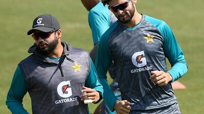 Pakistan's Azhar Ali, left, and Shaheen Shah Afridi warm up during a practice session. AFP