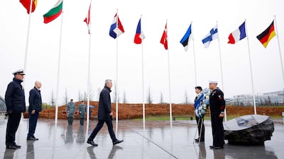 Mr Stoltenberg lays a wreath at the Flag Circle outside Nato Headquarters in Brussels. AFP