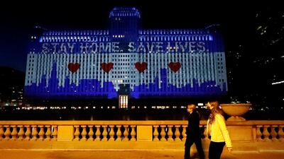 The Merchandise Mart in downtown Chicago is lit up to read "Stay Home Save Lives", during the coronavirus pandemic. AP Photo