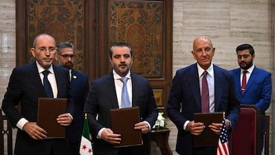 Syrian Foreign Minister Asaad Al Shibani, centre, with Jordan's Foreign Minister Ayman Safadi, left, and US special envoy for Syria Tom Barrack, after signing an agreement to restore calm to Druze-majority Sweida province. AFP
