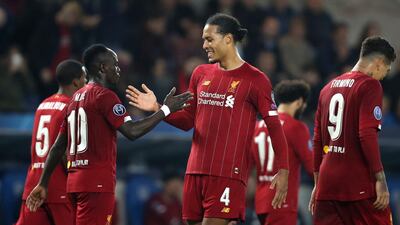 Sadio Mane, second left, is congratulated by Virgil van Dijk after scoring Liverpool's third goal. AP Photo