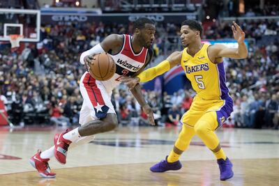 Washington Wizards guard John Wall, left, dribbles the ball beside Los Angeles Lakers guard Josh Hart. Michael Reynolds / EPA