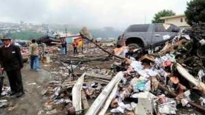 Residents survey the damage from a tsunami in the Chilean town of Talcahuano.
