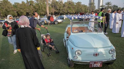 Visitors admire a vintage Fiat at The Grand Picnic by Flat 12 at Al Safa Park.