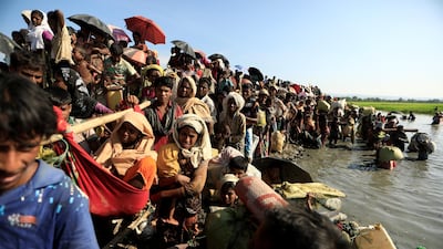Rohingya refugees who fled from Myanmar wait to be let through by Bangladeshi border guards after crossing the border in Palang Khali, Bangladesh October 16, 2017. REUTERS/ Zohra Bensemra