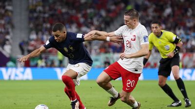 Kylian Mbappe of France is challenged by Piotr Zielinski of Poland. Getty