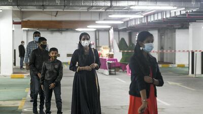 Parishioners wear mask at all times, maintain two-metre distance, and arrive early to prevent crowding at the entrance of St Paul's Catholic Church, in Mussafah. Khushnum Bhandari for The National