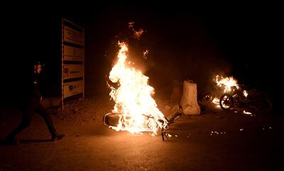 Supporters of religious group Tehrik Labaik Ya RasoolAllah (TLP) burn a bike during a protest over the Khadim Hussain Rizvi arrest in Karachi. EPA