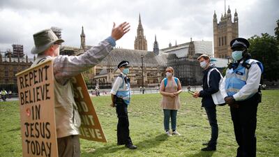 A religious preacher argues with Extinction Rebellion demonstrators. Getty