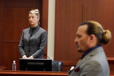 Amber Heard and Johnny Depp watch as the jury leaves the courtroom at the end of the day at the Fairfax County Circuit Courthouse in Fairfax, Virginia on May 16, 2022. AFP