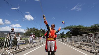 A man disguised as liberator Simon Bolivar performs during a ceremony to officially reopen the land border between Venezuela and Colombia – closed since 2019 – at the Simon Bolivar International Bridge, which connects San Antonio del Tachira in Venezuela and Cucuta in Colombia. AFP