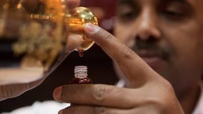 An employee from Areej Al Ameerat displays the retailer's exclusive oudh fragrance at Adihex yesterday.