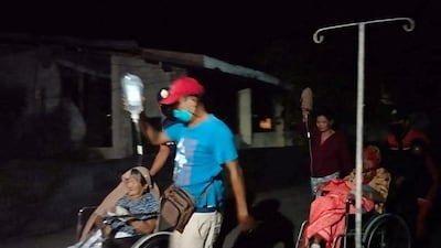 Rescuers evacuate a hospital after the earthquake in Ilocos Norte Province. Reuters